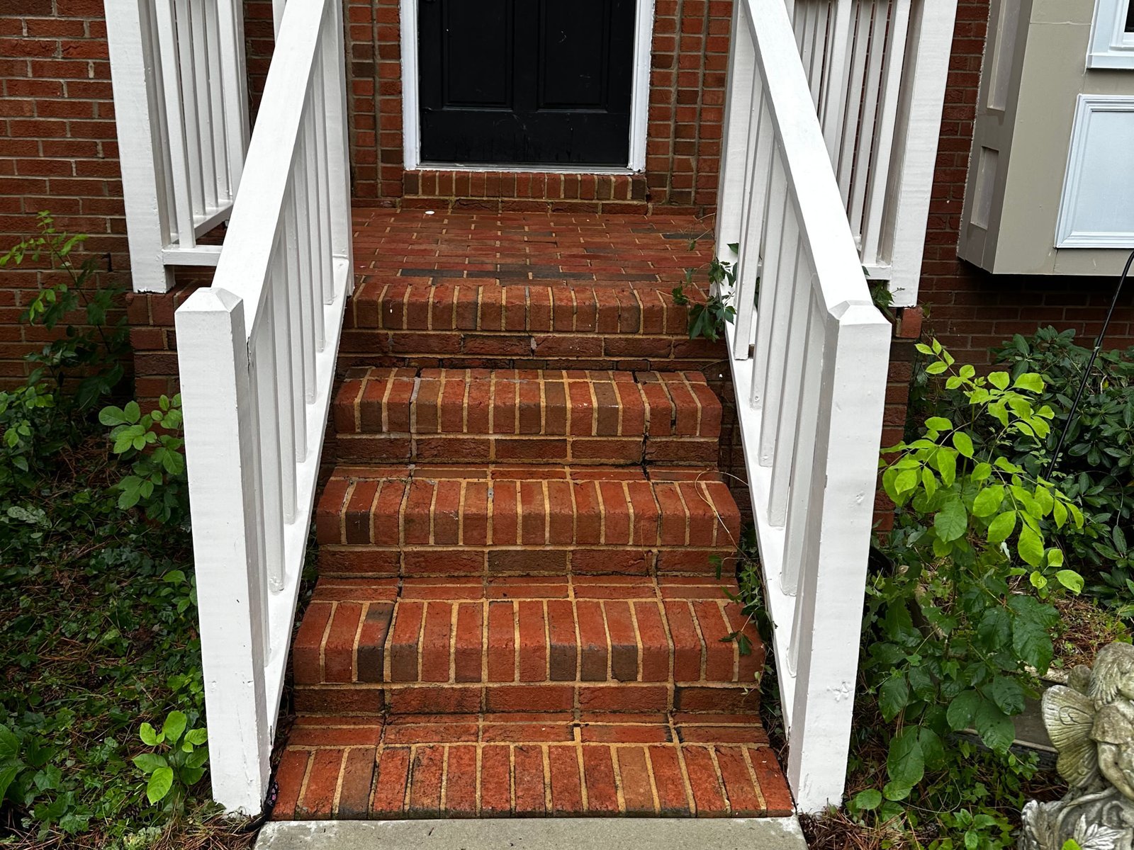 Restored red brick porch steps after cleaning